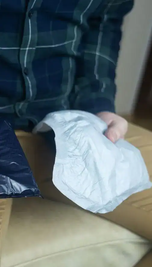 Image of man holding incontinence pads as part of overactive bladder treatment Bradford 